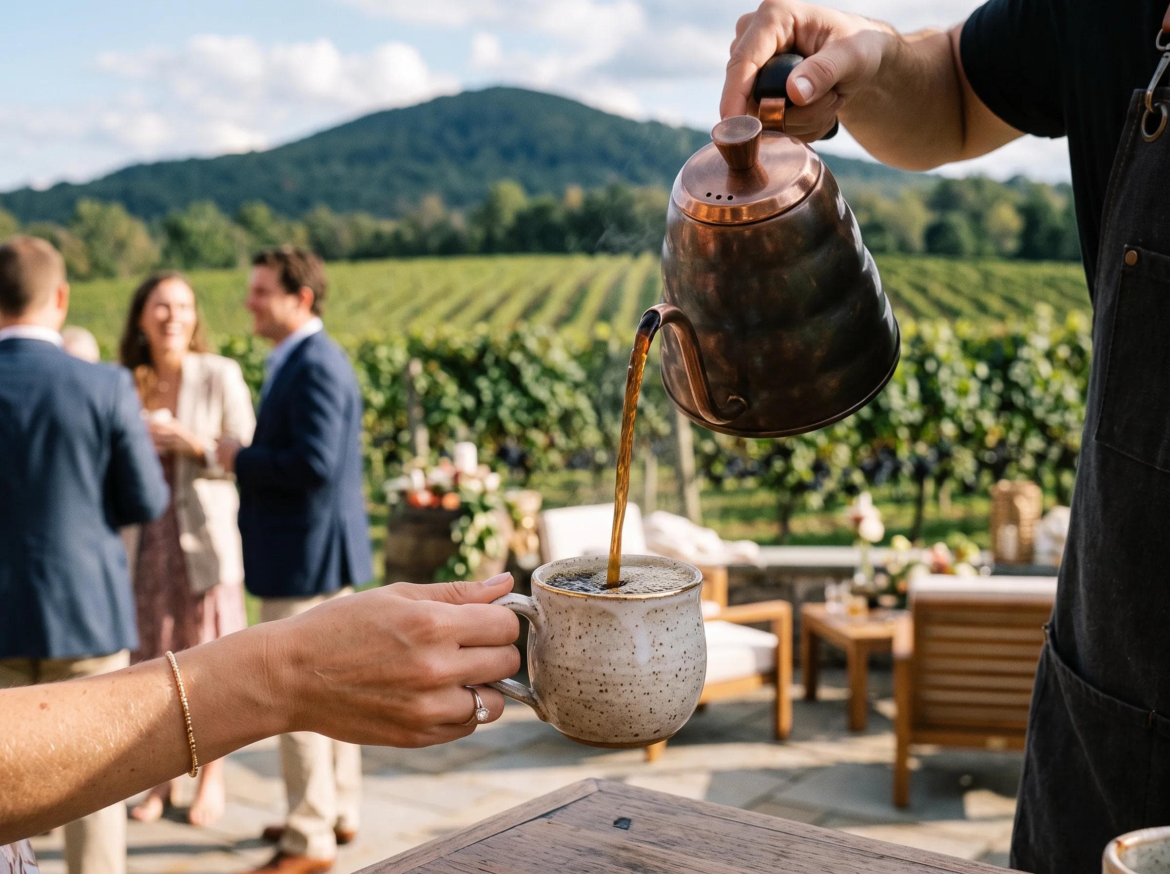 Close-up of a coffee pour at a vineyard estate wedding in Poolesville Maryland, Sugarloaf Mountain visible in soft-focus background